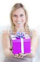 A charming woman is holding a present