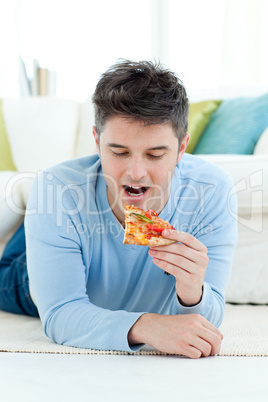 A young man eating pizza