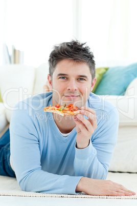 A young man holding a pizza