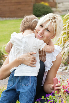 Little child embrace her smiling mother