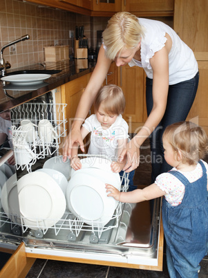 Family besides open dishwasher
