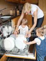 Family besides open dishwasher