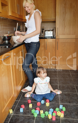 Smiling mother playing child