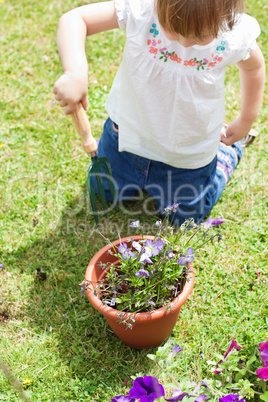 Little girl with a flowerpot
