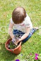 Sweet girl planting a flower