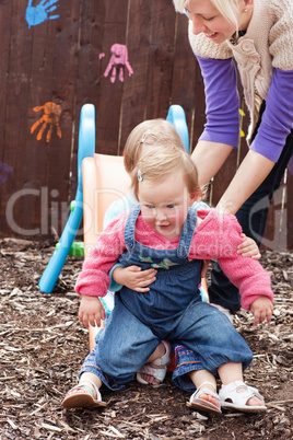 Sweet children sitting on a chute