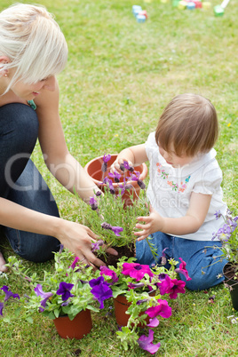 Glowing mother and her daughter with flowers