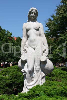 White statue of woman in the city park