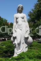 White statue of woman in the city park