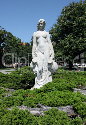 White statue of woman in the city park