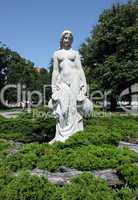 White statue of woman in the city park