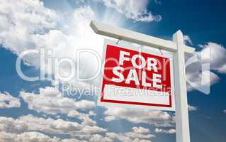 For Sale Real Estate Sign over Clouds and Blue Sky