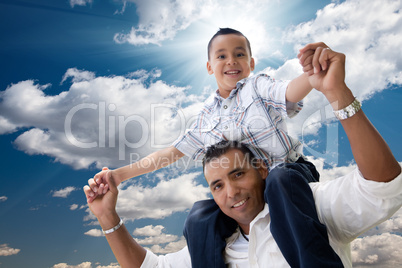 Hispanic Father and Son Having Fun Over Clouds
