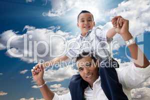 Hispanic Father and Son Having Fun Over Clouds