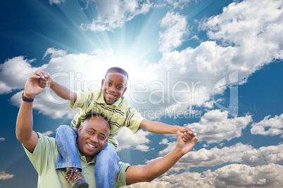 Happy African American Man with Child Over Clouds and Sky