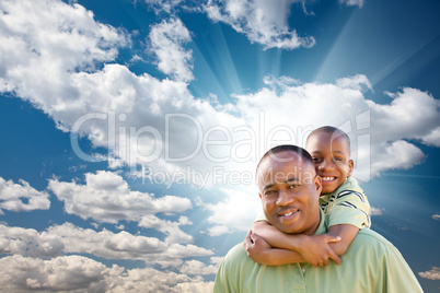 Happy African American Man with Child Over Clouds and Sky