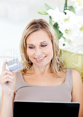 Delighted woman holding a card