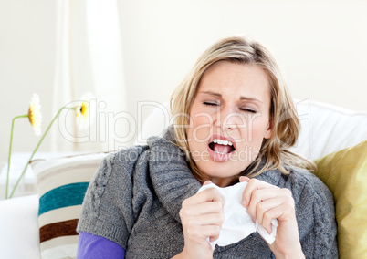 Young woman sneezes
