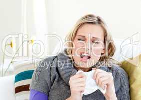 Young woman sneezes
