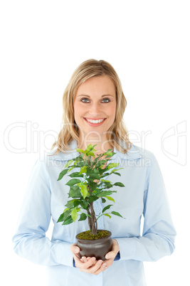 Pretty woman holding a plant in her hands