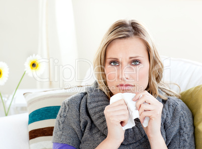 Unhealthy woman sitting on a sofa