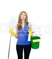 Thinking woman with cleaning utensils