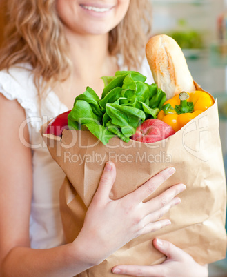 Smiling woman holding a shopping bag