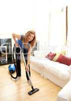 Smiling woman use vacuum cleaner