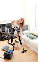 Handsome woman cleaning her living room
