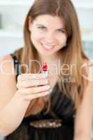 Smiling woman holding lipstick in the camera