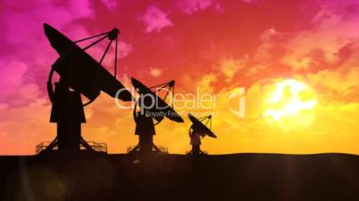 Satellite dish antennas at sunset