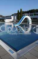 dispeopled bath pool with white slide