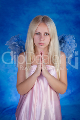 Beautiful girl posing on a blue background