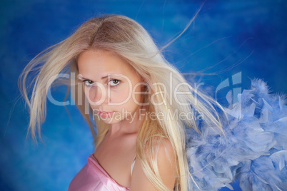 Beautiful girl posing on a blue background