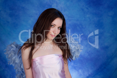 Beautiful girl posing on a blue background