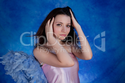 Beautiful girl posing on a blue background