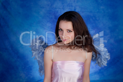 Beautiful girl posing on a blue background