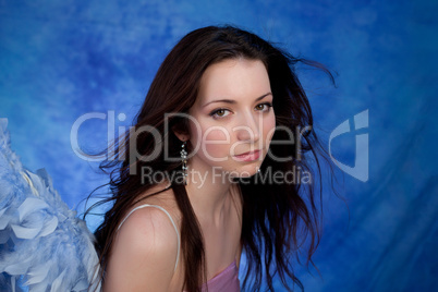 Beautiful girl posing on a blue background