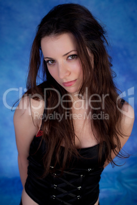 Beautiful girl posing on a blue background