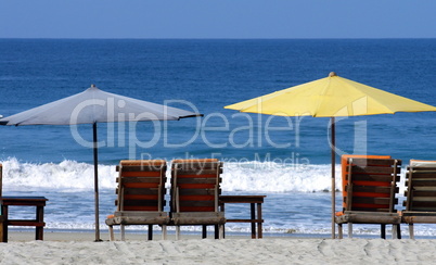 colorful beach umbrellas with seats