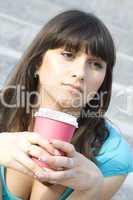 Female in a park drinking coffee