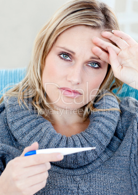 Unhappy woman taking her sick tempretaure