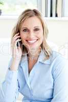Handsome confident businesswoman using a mobile phone
