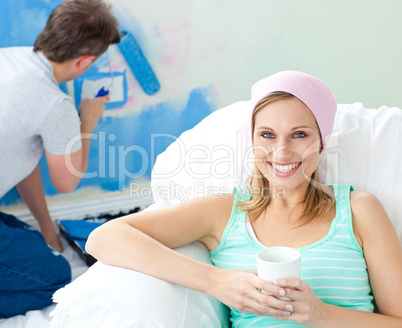 Relaxing smiling woman sitting on the sofa
