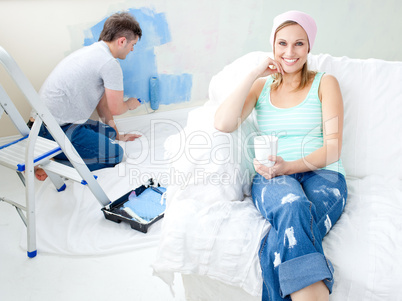 Smiling  young woman sitting on the sofa