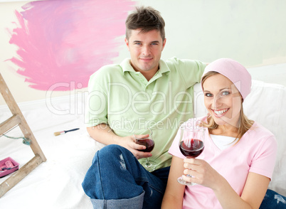 Delighted couple having free time together with a glass of wine