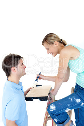 Happy couple painting a room