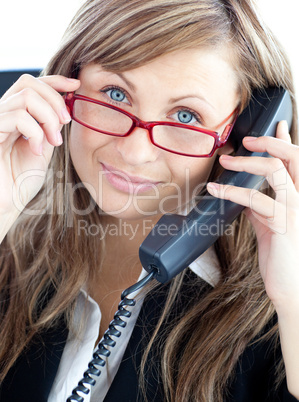 Attractive business woman on phone  wearing red glasses