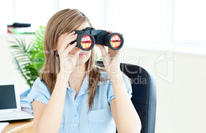 Young businesswoman holding spyglass