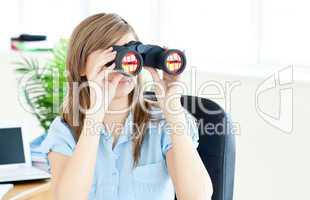 Young businesswoman holding spyglass